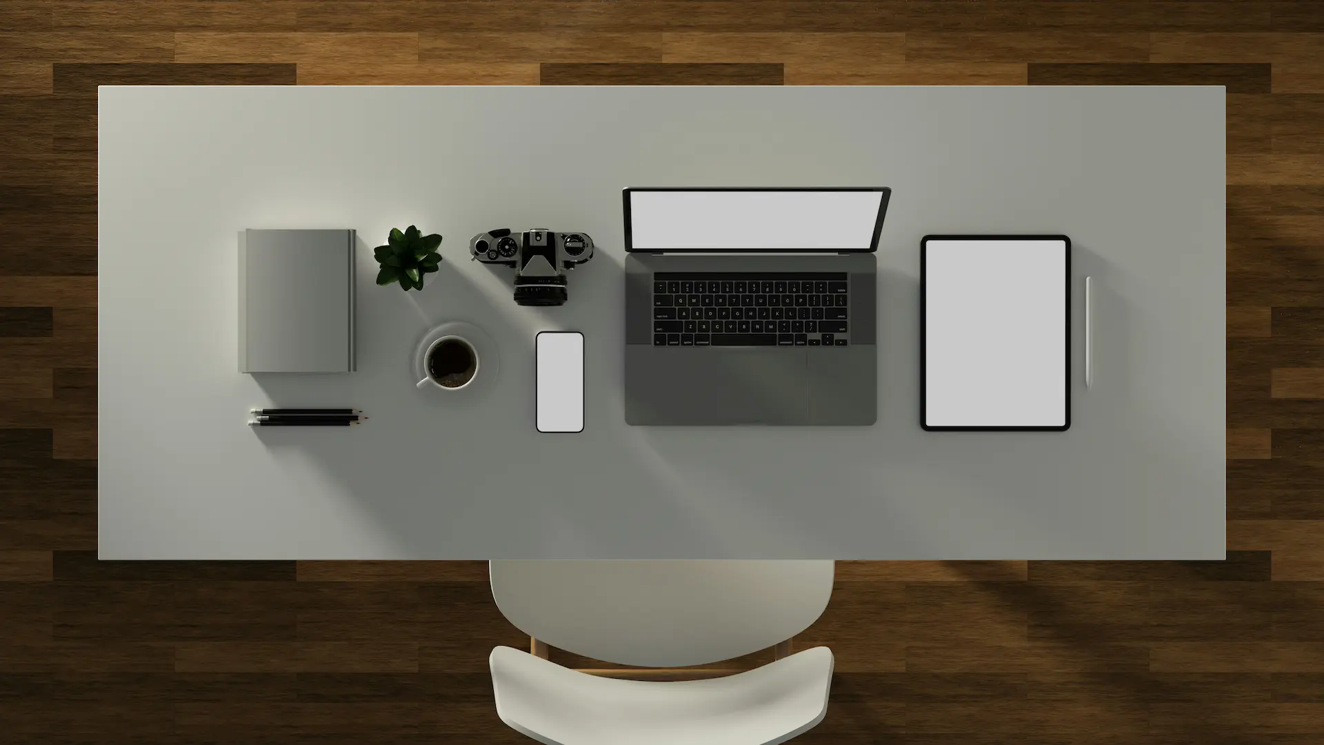 Multiple computers and mobile devices on a desk